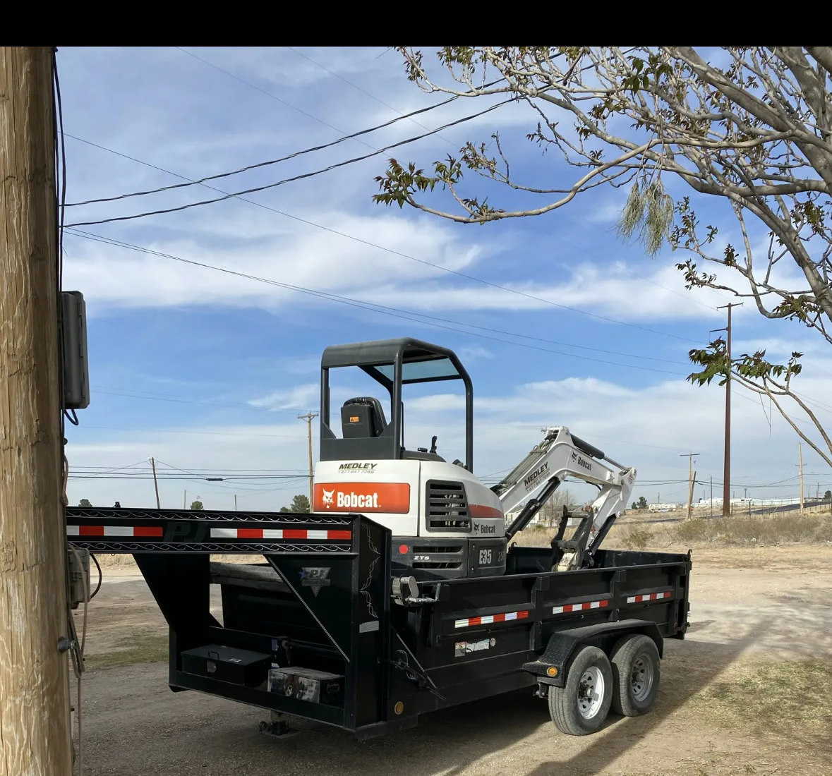 Bobcat mini excavator loaded on a gooseneck dump trailer
